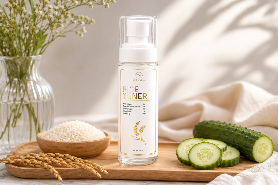 Milky Moon Rice Toner bottle with rice extract, cucumber extract, niacinamide, vitamin B5, and vitamin E, displayed beside rice grains and fresh cucumber slices for glowing, hydrated skin.